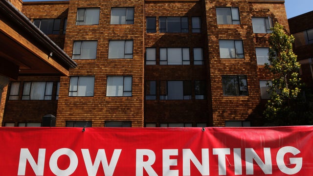 Apartment complex with "now renting" sign 